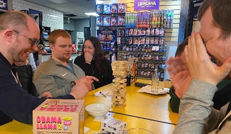 People at table playing a game