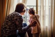 Maria and child looking out the window