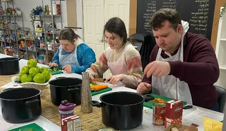 3 people at table prepping food