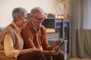 Maureen and Bill looking at a tablet